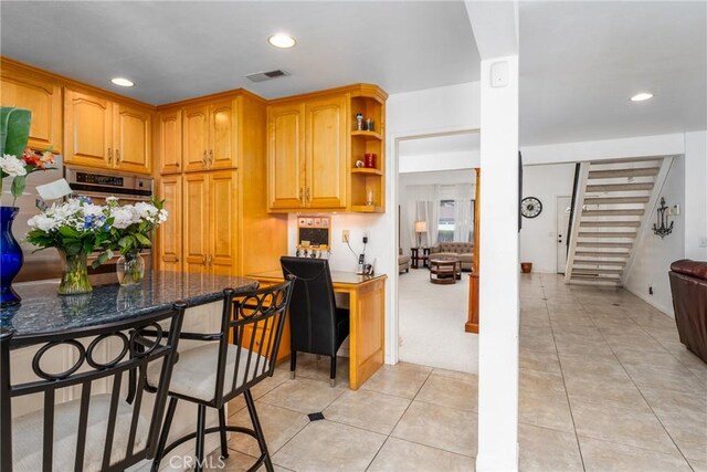 kitchen with recessed lighting, visible vents, built in study area, and light tile patterned floors