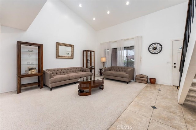 living room featuring light colored carpet, stairway, light tile patterned flooring, high vaulted ceiling, and recessed lighting