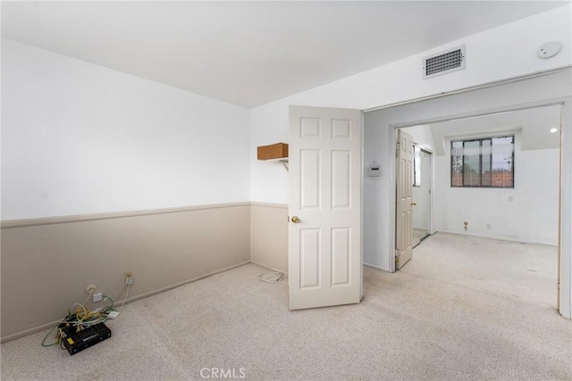 spare room featuring carpet and visible vents