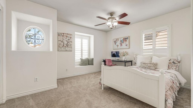 carpeted bedroom with baseboards and ceiling fan