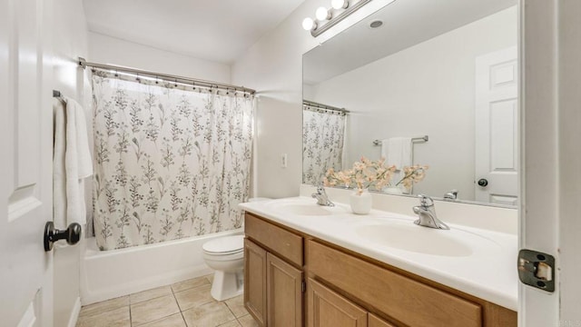 bathroom with toilet, double vanity, shower / tub combo, tile patterned floors, and a sink