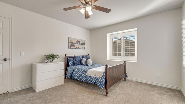 bedroom featuring baseboards, light carpet, and ceiling fan