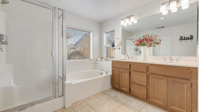 bathroom featuring visible vents, a stall shower, and a sink