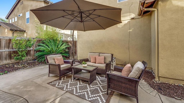 view of patio / terrace with an outdoor hangout area and fence