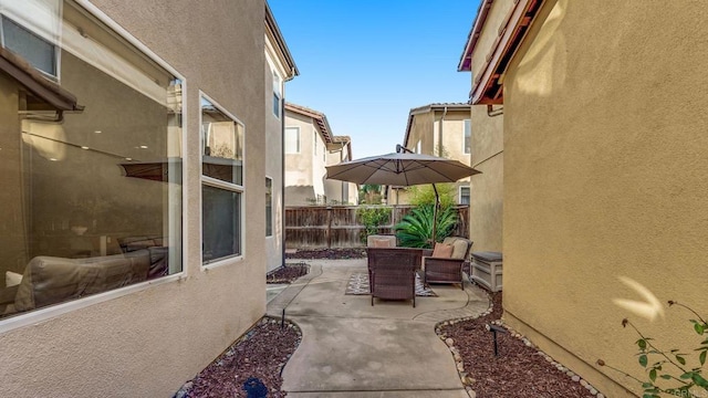 view of patio featuring fence