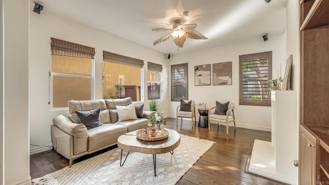 living room with a ceiling fan, dark wood-style floors, and baseboards