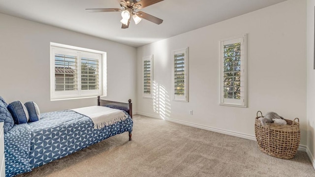 bedroom with a ceiling fan, carpet, and baseboards