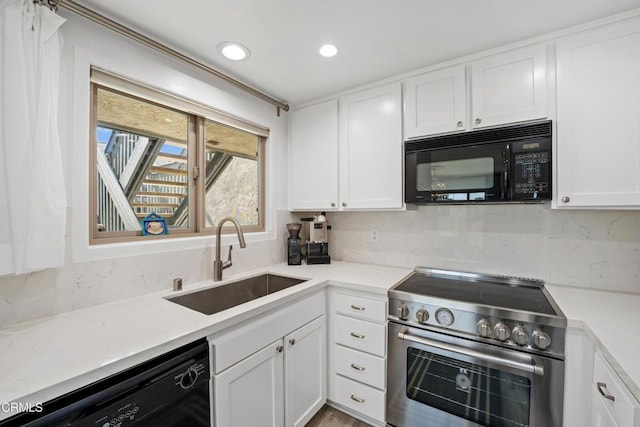 kitchen with decorative backsplash, white cabinets, a sink, light stone countertops, and black appliances