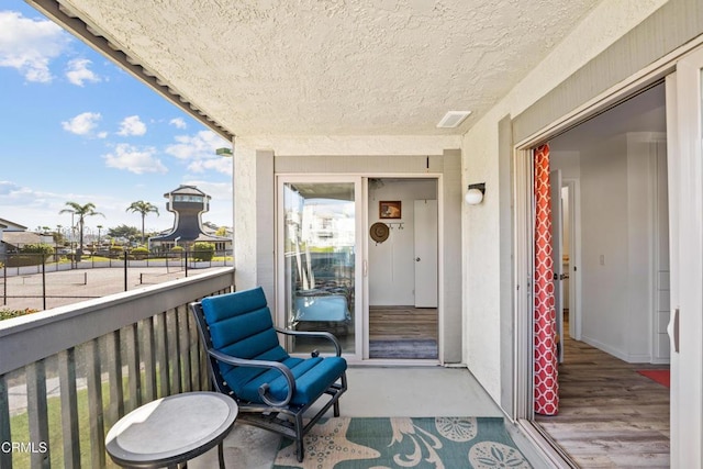 balcony with a sunroom and visible vents