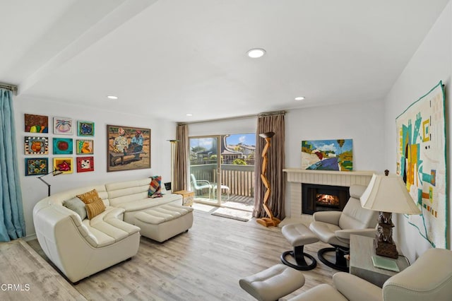 living area featuring a fireplace, wood finished floors, and recessed lighting