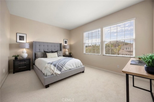 carpeted bedroom featuring baseboards