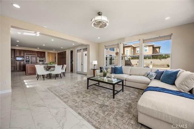 living room with baseboards, marble finish floor, and recessed lighting