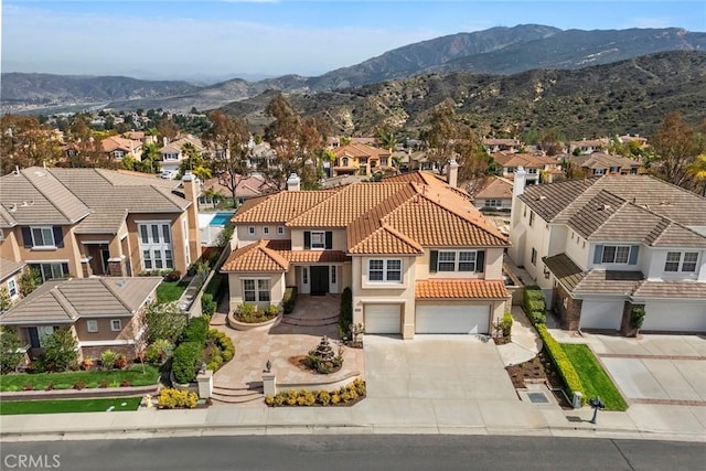 birds eye view of property with a mountain view and a residential view