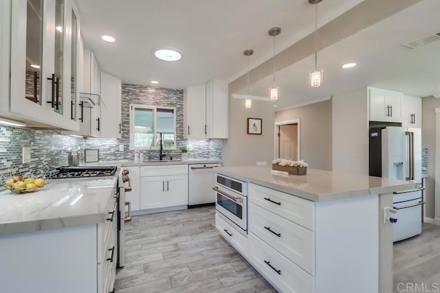 kitchen with pendant lighting, backsplash, white cabinetry, a kitchen island, and white appliances