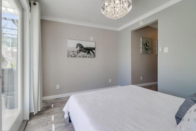 bedroom featuring baseboards, a chandelier, crown molding, and wood finished floors