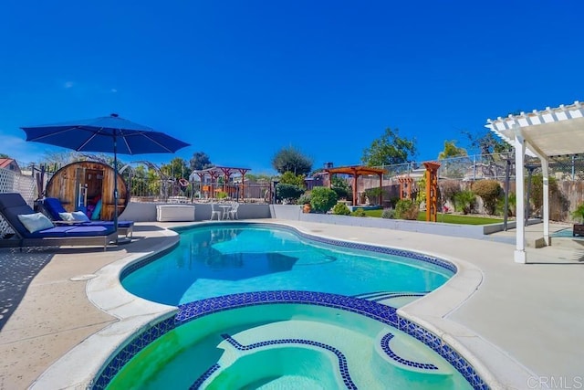 view of pool featuring a patio, fence, a pool with connected hot tub, and a pergola