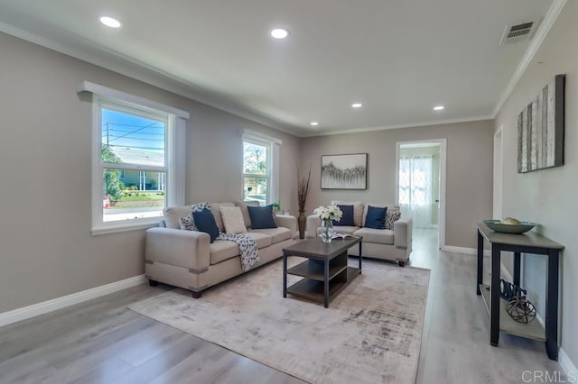 living area featuring baseboards, wood finished floors, and ornamental molding