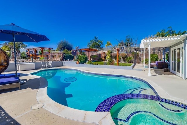 view of pool featuring a patio area, fence, a pool with connected hot tub, and a pergola