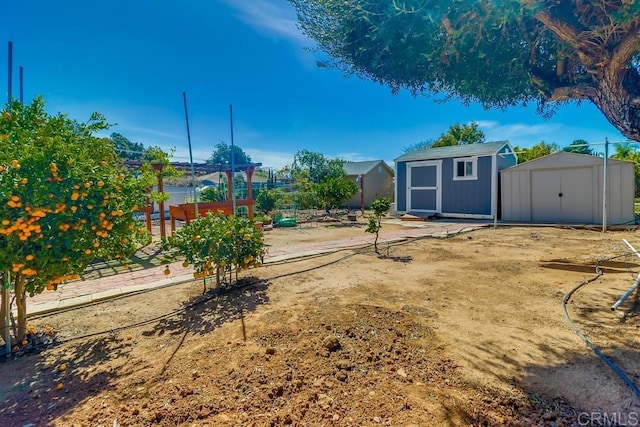 view of yard featuring a storage shed and an outbuilding