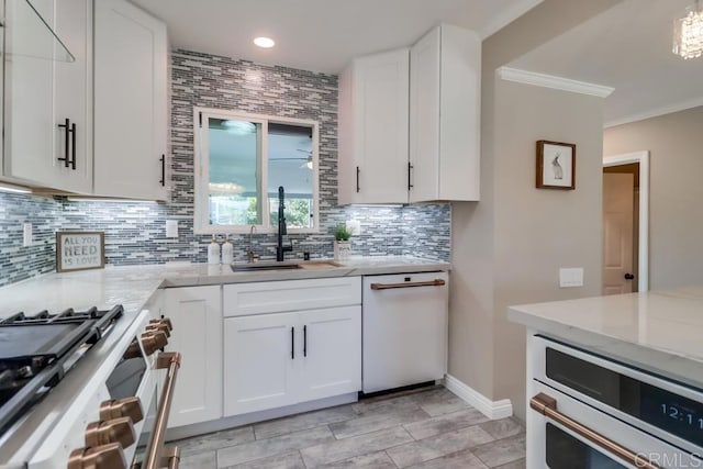 kitchen featuring a sink, white cabinets, range, dishwasher, and tasteful backsplash