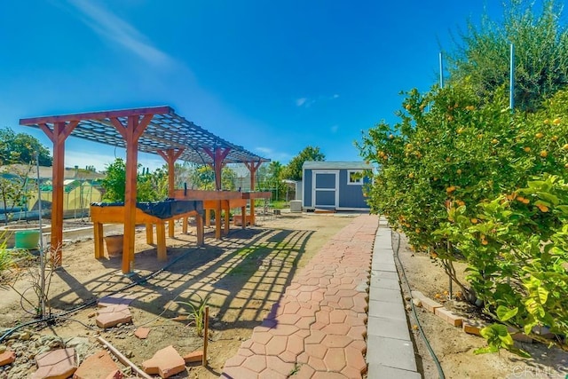 view of patio / terrace with an outbuilding, a shed, and fence