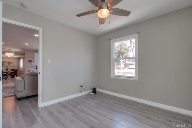 washroom with laundry area, baseboards, wood finished floors, ceiling fan with notable chandelier, and recessed lighting