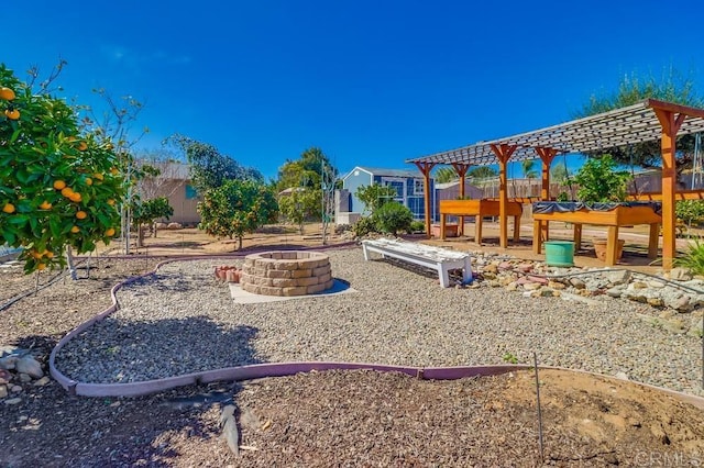 view of jungle gym featuring fence, a fire pit, and a pergola