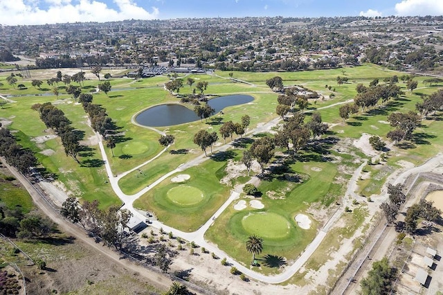 drone / aerial view featuring view of golf course and a water view