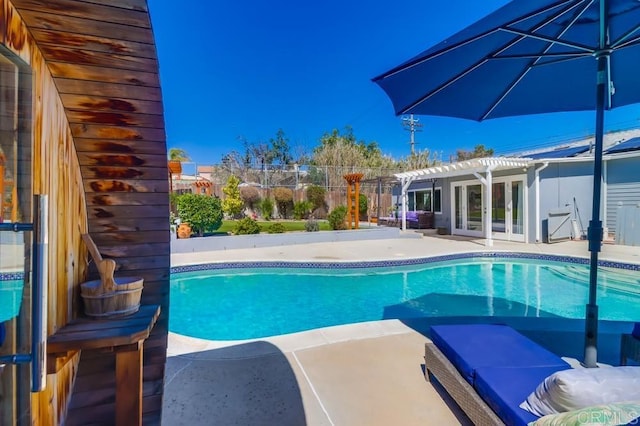 pool featuring french doors, a patio area, fence, and a pergola