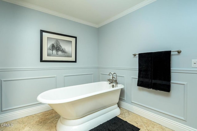 full bathroom with crown molding, a decorative wall, wainscoting, and a freestanding bath