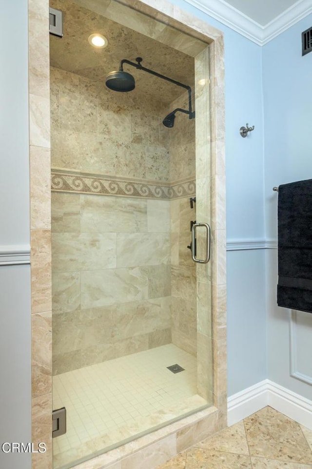 full bath featuring crown molding, visible vents, a stall shower, and baseboards