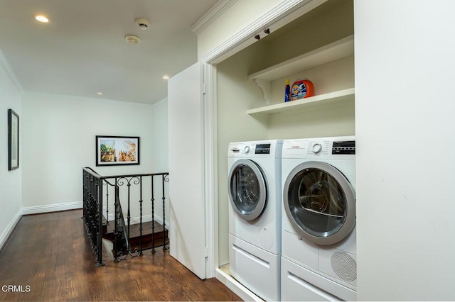 laundry room with dark wood-style floors, laundry area, independent washer and dryer, and ornamental molding