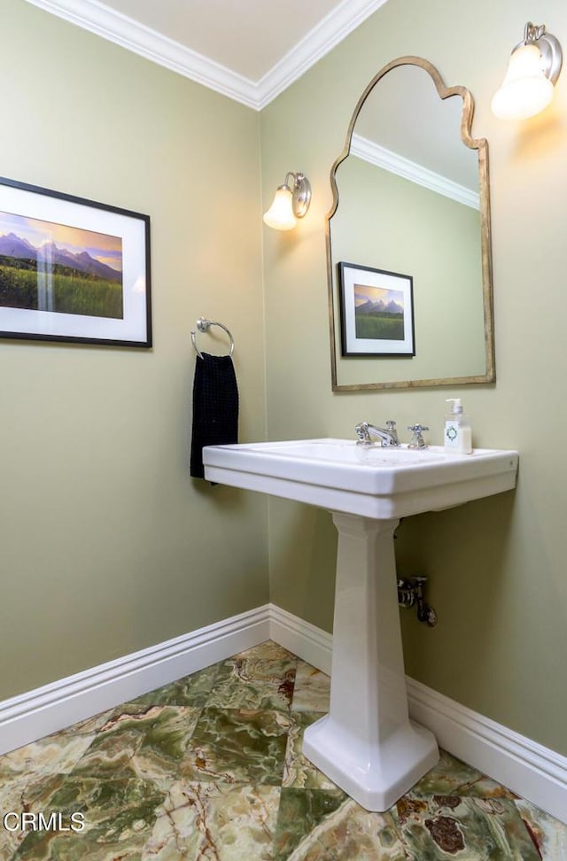 bathroom with crown molding and baseboards