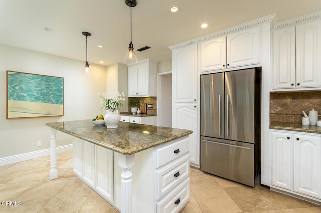 kitchen with backsplash, a center island, dark stone countertops, white cabinets, and high end fridge