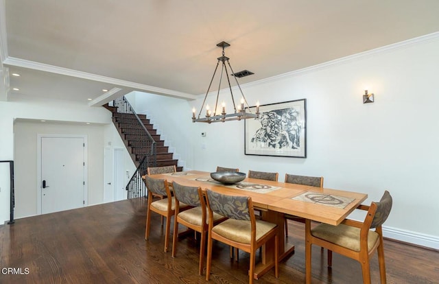 dining room featuring stairway, crown molding, visible vents, and wood finished floors