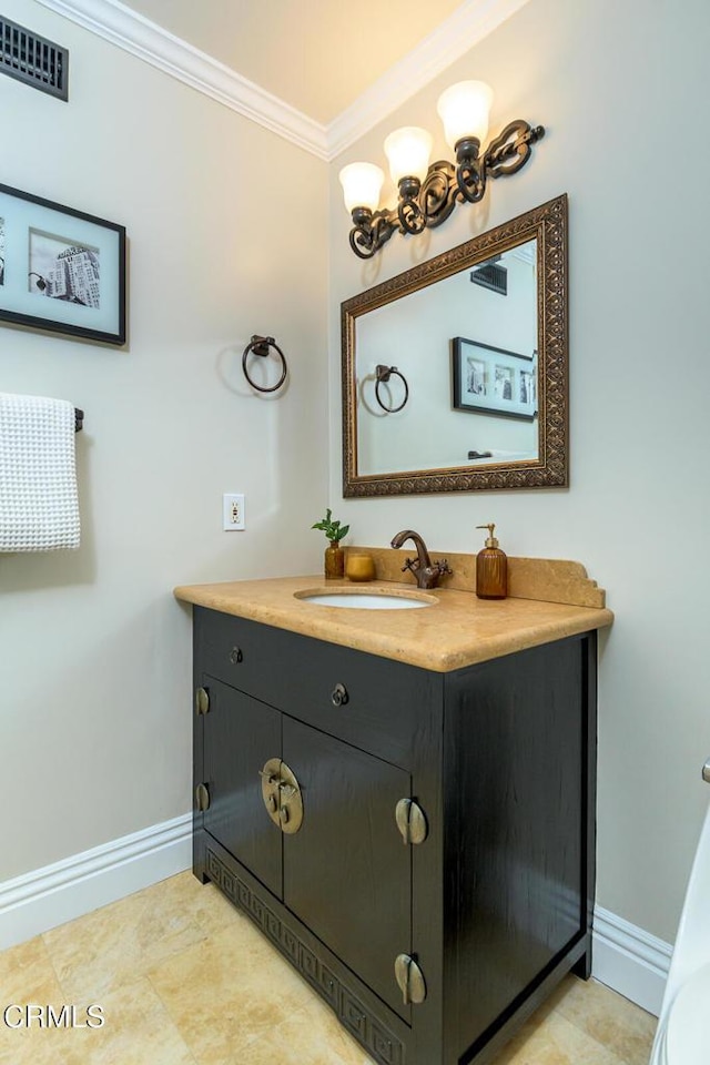 bathroom featuring visible vents, vanity, crown molding, and baseboards