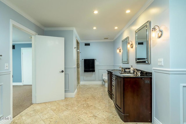 full bathroom with a decorative wall, vanity, a shower stall, and crown molding