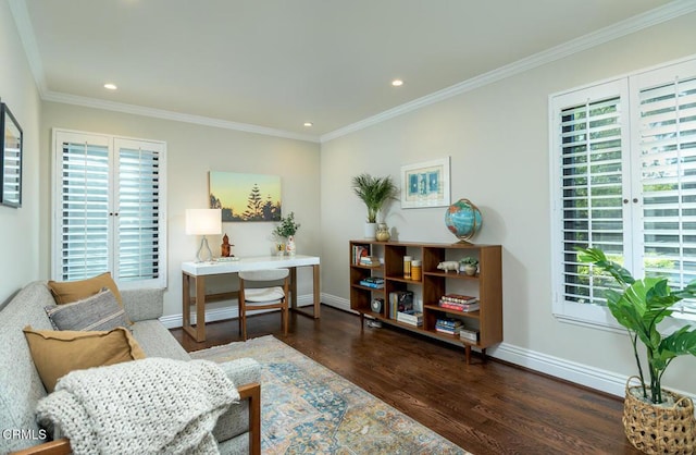 sitting room featuring baseboards, a healthy amount of sunlight, and wood finished floors