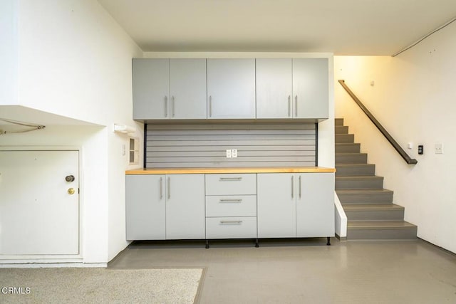 kitchen with wooden counters and gray cabinetry