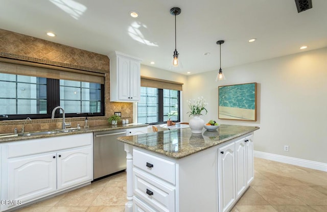 kitchen with visible vents, a sink, stone countertops, stainless steel dishwasher, and backsplash