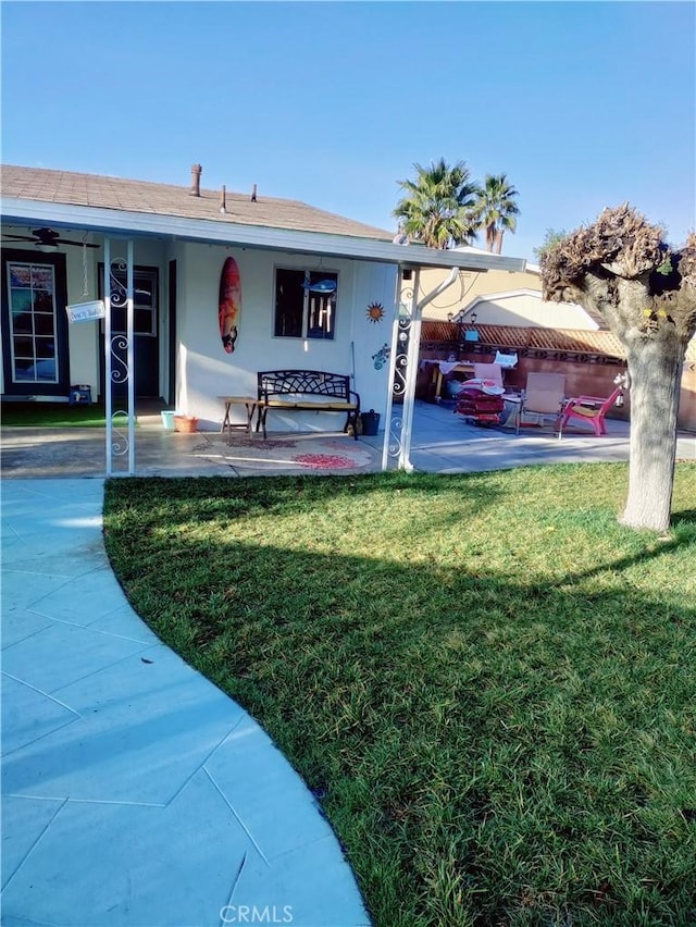 exterior space featuring a patio and a front lawn