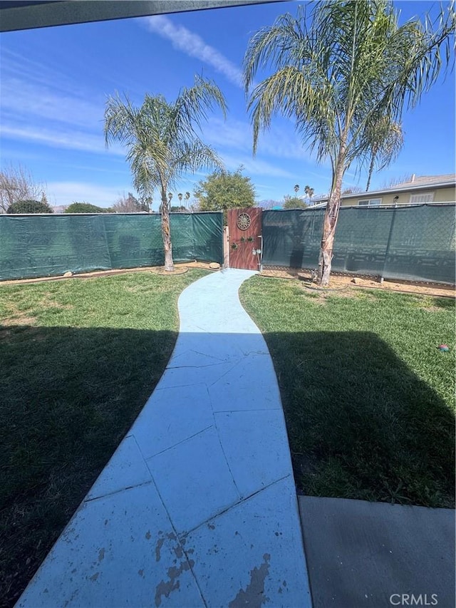 view of yard featuring fence private yard and a gate
