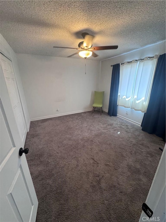 unfurnished bedroom with baseboards, a textured ceiling, a ceiling fan, and carpet