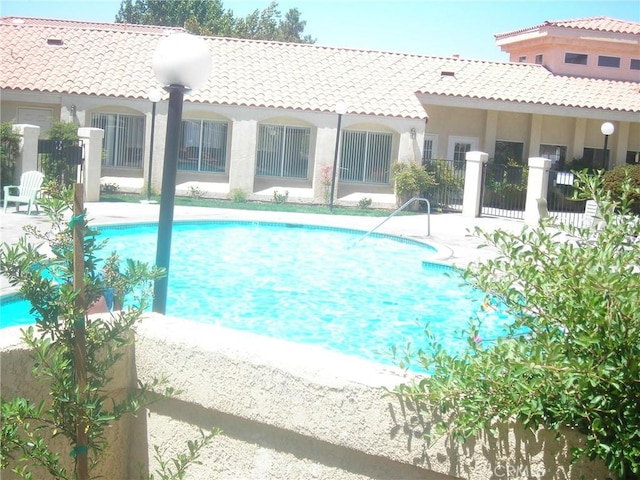 view of pool with fence, a fenced in pool, and a patio