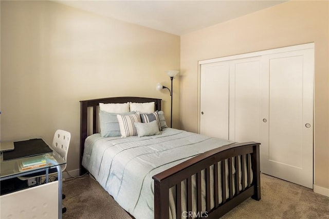 bedroom featuring a closet, carpet flooring, and baseboards