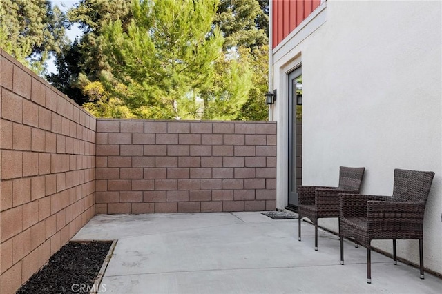 view of patio featuring fence