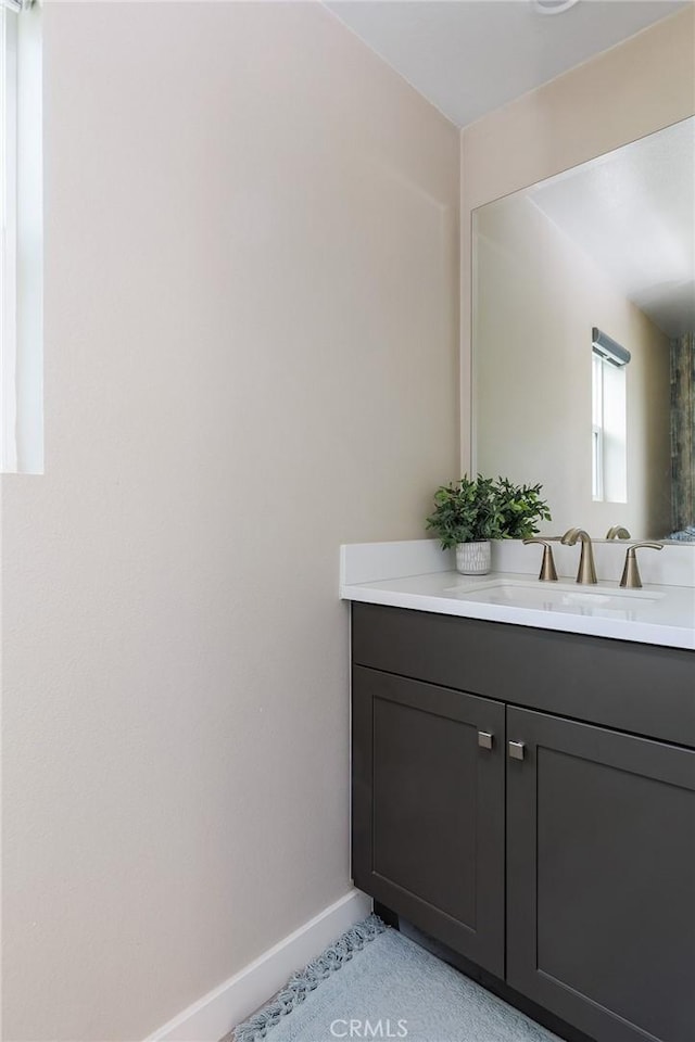 bathroom featuring vanity and baseboards