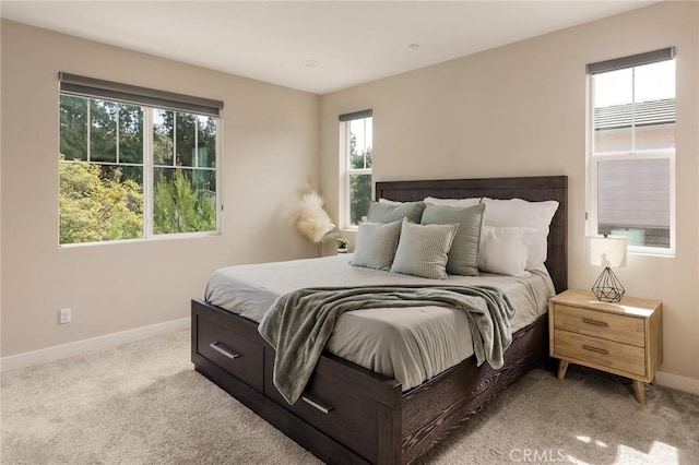 bedroom with light carpet and baseboards