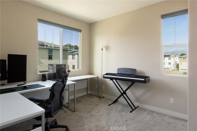 home office featuring baseboards and light colored carpet