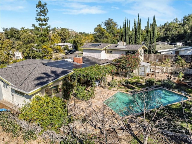 outdoor pool with a shed, fence, an outdoor structure, and a patio